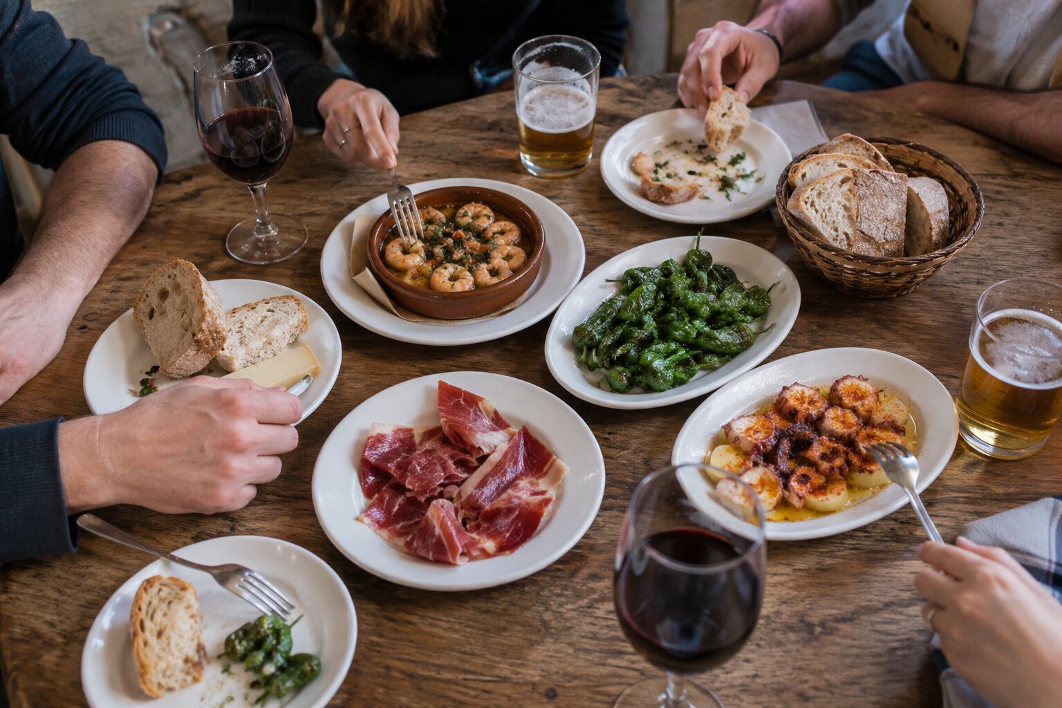 A shared table of hearty plates at G cafe Bilbao